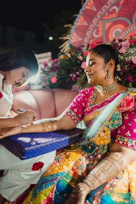 Bride in colorful lehenga at her mehendi ceremony at night