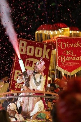 Groom's baraat entry with fog cannon and confetti at night