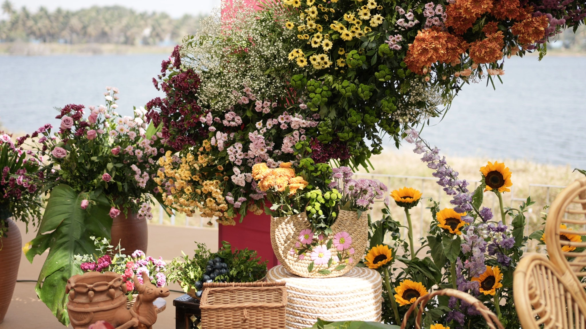 Colorful floral wedding by luxury wedding planners in bangalore -decoration with sunflowers, roses and greenery beside a lakeside setting