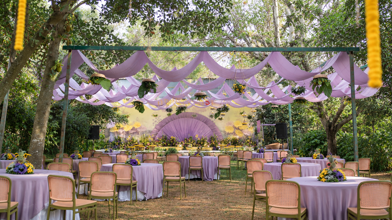 Lavender-themed outdoor wedding décor by Dreamstrokes featuring floral stage decorations, elegant table settings, and a garden canopy.Luxury wedding planning ideas in Bangalore